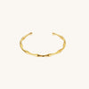 Gold bamboo textured bracelet on a white background