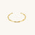Gold bamboo textured bracelet on a white background