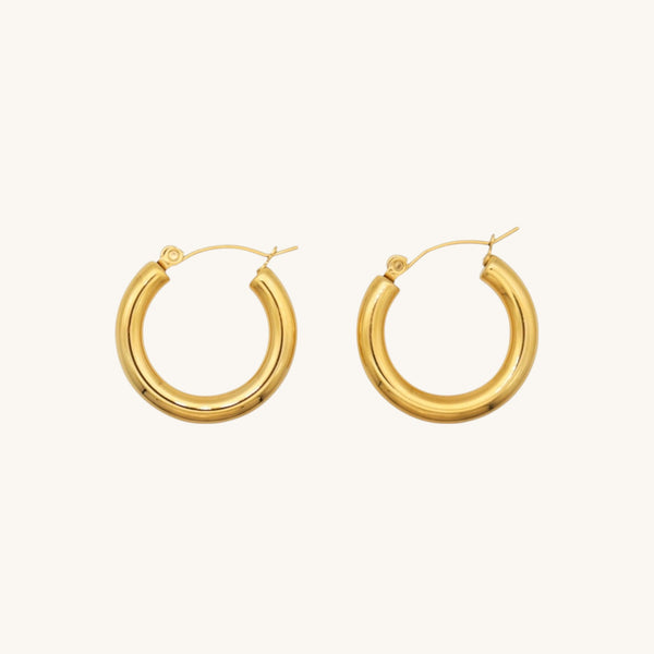 Gold hoop earrings on a white background