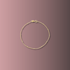 Gold bracelet on a gradient pink background